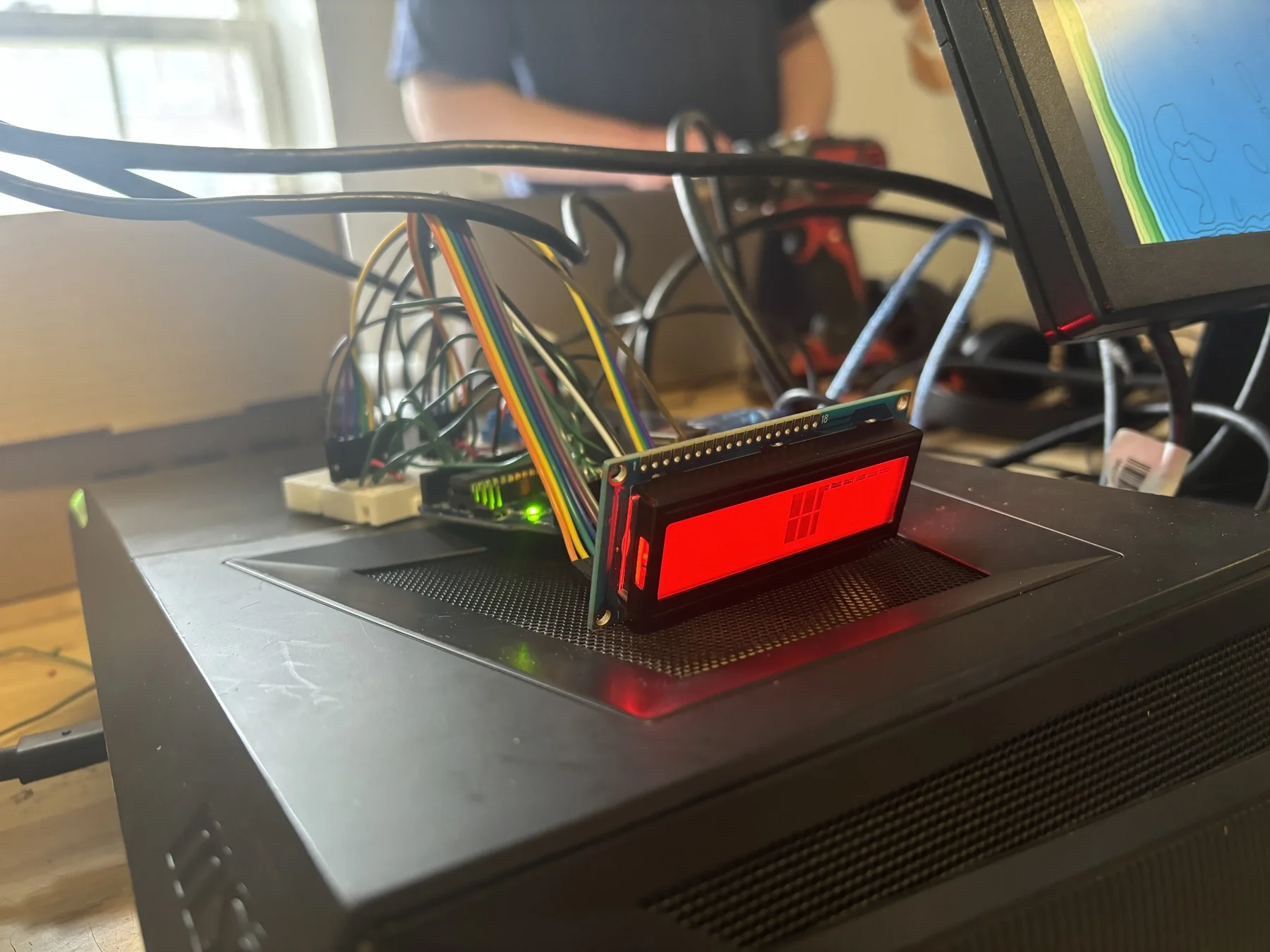 Arduino display system showing red LCD with unlock codes